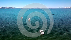 Aerial push forward shot, footage over Lake Tahoe and boats, sunny day