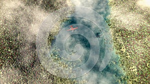 Aerial of red airplane flying over spring meadow with river.