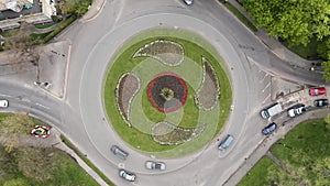 Aerial reveal of busy traffic roundabout