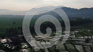 Aerial of rice fields and tropical mountains in West Java, Indonesia.