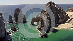 Aerial, rising, tilting towards the Arch of Cabo San Lucas, Mexico