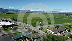 Aerial of the road and farmland with the mountains in the background in Bozeman, Montana.