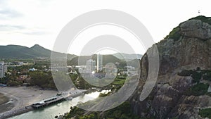 AERIAL. Rock cave uncovering panorama of Hua Hin, Thailand.