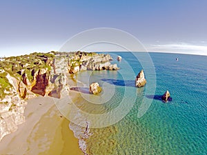 Aerial from rocks and ocean at Praia tres Irmaos in Algarve Port photo