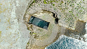 Aerial rotating top-down view of famous Poll na bPeist or the Wormhole, Ireland