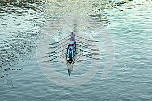 aerial of rower at the river in an five people boat