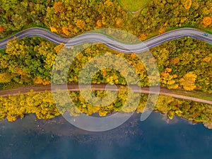 Aerial scenery view of winding road and railway beside in autumn fall