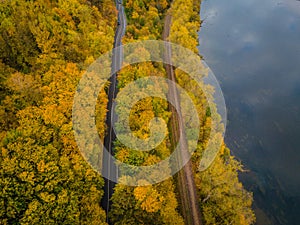 Aerial scenery view of winding road and railway beside in autumn fall