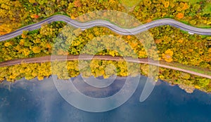 Aerial scenery view of winding road and railway beside in autumn fall