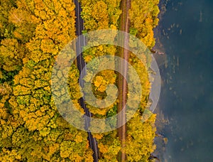 Aerial scenery view of winding road and railway beside in autumn fall