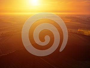 Aerial scenic view of sunrise ofer green grain field