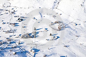 Aerial scenic rural view of the winter landscape from Fundata village in Romania at the bottom of Bucegi Mountains