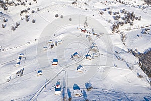 Aerial scenic rural view of the winter landscape from Fundata village in Romania at the bottom of Bucegi Mountains photo