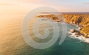 Aerial seascape of Australian coastline with sunrise sky