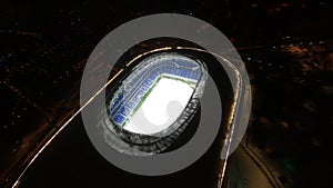 Aerial shoot of Football stadium. drone flies inside through the roof hole