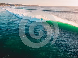 Aerial shooting of big green waves at sunset. Biggest ocean waves in Bali