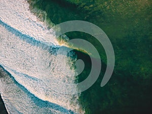 Aerial shooting of big stormy waves at sunset. Background with ocean wave