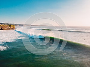 Aerial shooting of big stormy waves at sunset. Biggest ocean wave in Bali