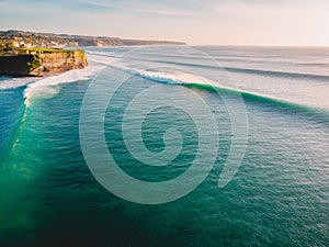 Aerial shooting of big waves at sunset. Biggest ocean waves in Bali and coastline