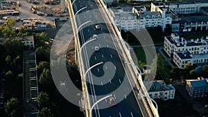 Aerial shooting from flying drone car traffic on modern highway bridge over sea