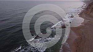 Aerial shooting of sea waves and shore of beautiful rocks