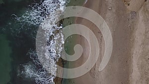 Aerial shooting of sea waves and shore of beautiful rocks