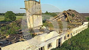 Aerial shot of an abandoned cattle barn slowly decaying.