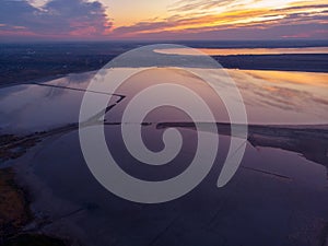 Aerial shot above Odessa Kuyalnik liman. A mud baths retreat clinic center in Ukraine, calm water sunset reflection