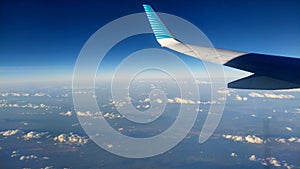 aerial shot with airplane wing and a beautiful horizon where heaven and earth merge