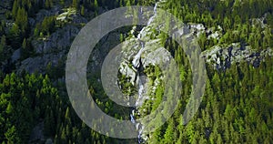 Aerial shot of alpine waterfall in the italian alps