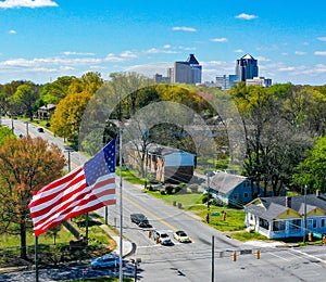 Aerial  shot of the American flag  and Greensboro, NC skyline on the horizon on a spring day photo