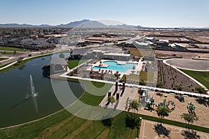 Aerial shot of the Arizona fountain park with swimming pool and new homes
