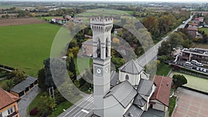 Aerial shot around the bell tower of an Italian church