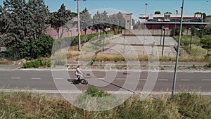 Aerial shot : Attractive Man rides his foldable electric bike on the street