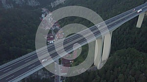 Aerial shot of Austrian highway bridge above small town in the evening