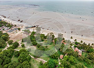 An aerial shot of Bagamoyo, Tanzania. Curve of Indian Ocean Beachline Coast with Vessels