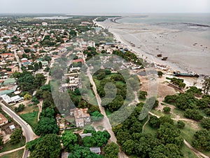 An aerial shot of Bagamoyo, Tanzania. Curve of Indian Ocean Beachline Coast with Vessels