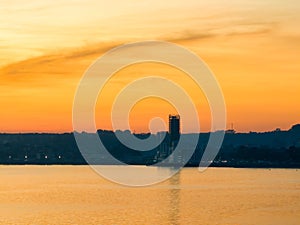 Aerial shot of the bay of the city of Puerto Montt with golden sunset light.