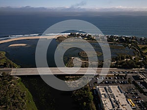 Aerial shot of the beach covered with buildings and a bridge, Los angeles, Malibu