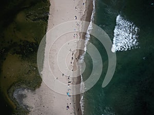 Aerial shot of the beach with the waves of water crashing on the shore, Los angeles, Malibu