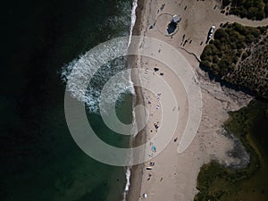 Aerial shot of the beach with the waves of water crashing on the shore, Los angeles, Malibu