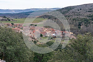 Aerial shot of beautiful Caracena town buildings on amazing landscape background photo