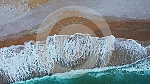 Aerial shot of beautiful sea waves on the beach