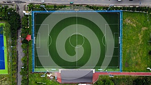 Aerial shot of big modern stadium. Top view at the stadium with green lawn