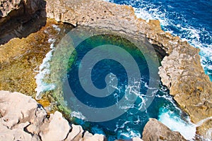 Aerial shot of a Blue Hole, a famous diving spot on Gozo island, Malta on a sunny day