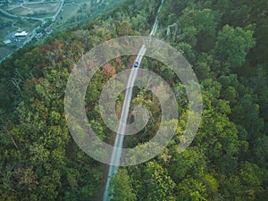 aerial shot blue vintage retro dune buggy circulating on the road on the hills of Apennines in Italy