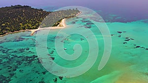 Aerial shot of the boat moving in the blue and clear waters of the Aegean Sea with a drone