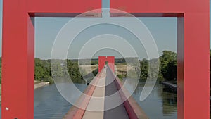 Aerial shot of bridge on Oise River with red arches