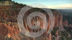 Aerial shot of bryce canyon national park passing low over cliffs