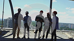 Aerial Shot Of Builders Team On Construction Site Discussing Plan Of Project With Architect And Contractor Using